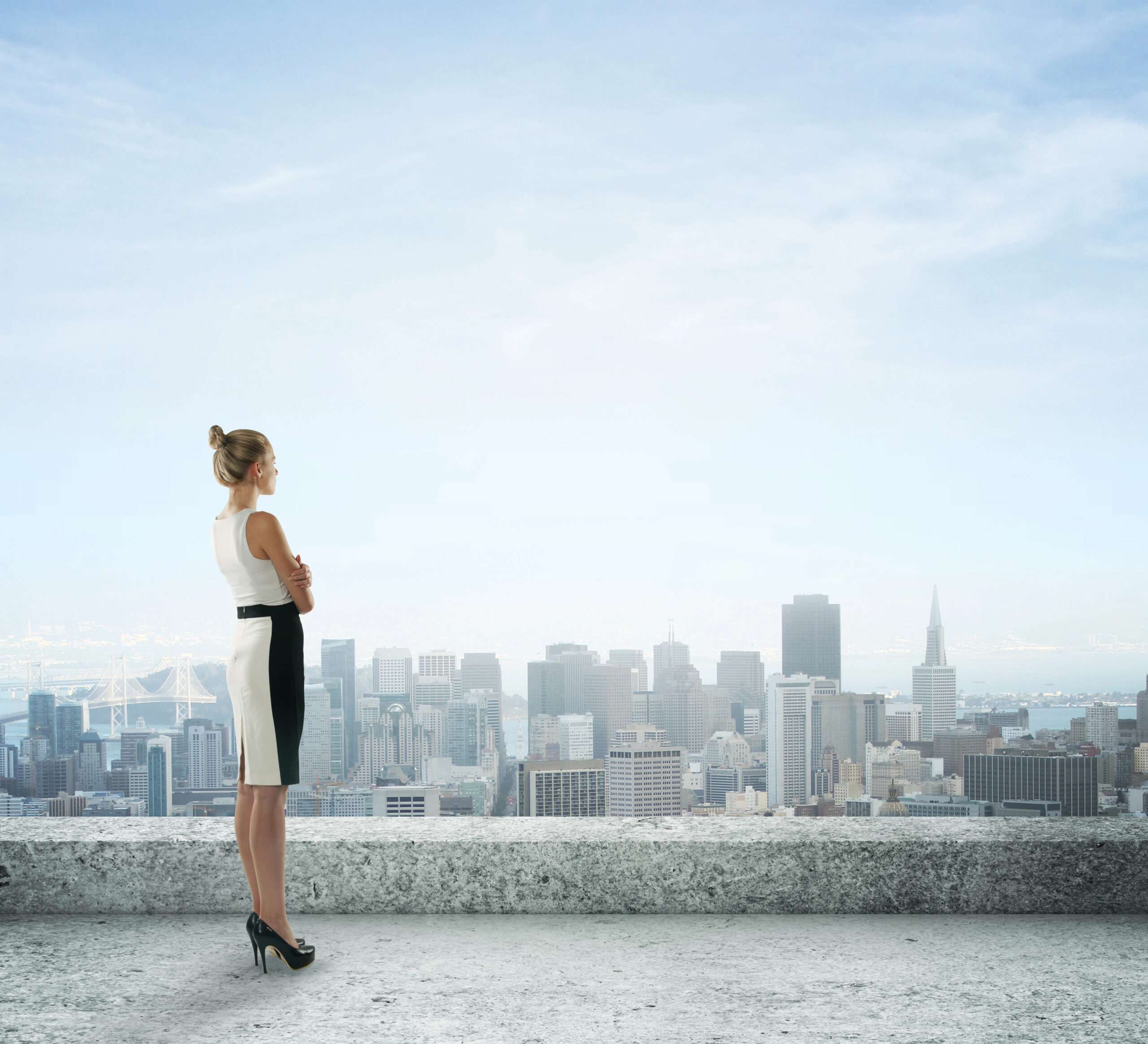 Photo of a confident professional woman staring out at a skyline